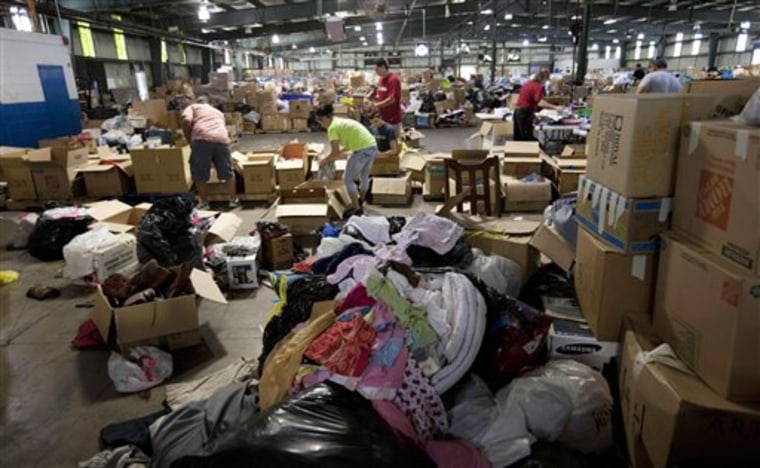 Volunteers sort through donated clothing at a warehouse in Tuscaloosa, Ala.